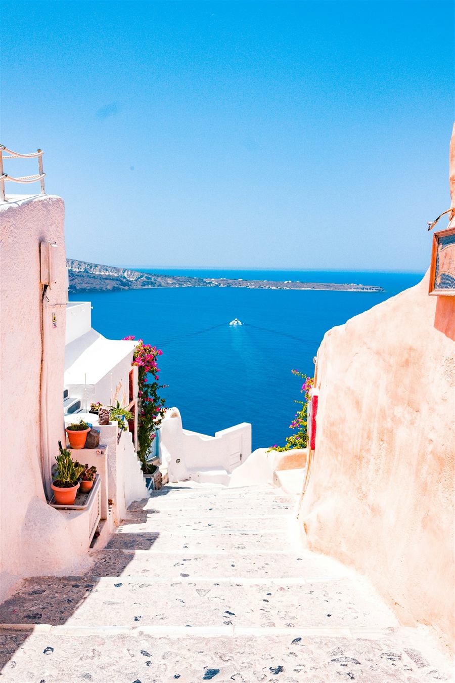 Whitewashed steps overlooking the deep blue Aegean sea in Santorini