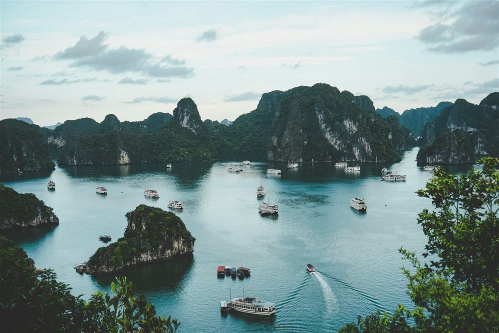Limestone karsts and small boats in Ha Long Bay