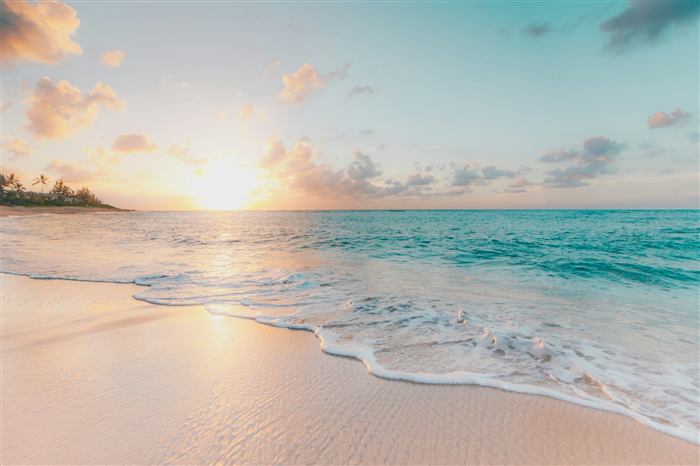 Golden sunset over a quiet beach with gentle waves
