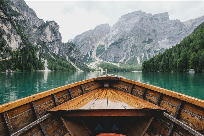 Turquoise mountain lake with a wooden boat