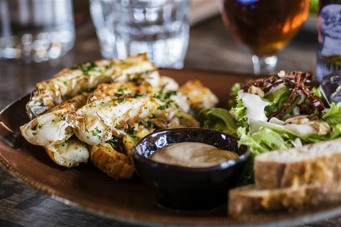 Grilled dishes and salad on a shared plate