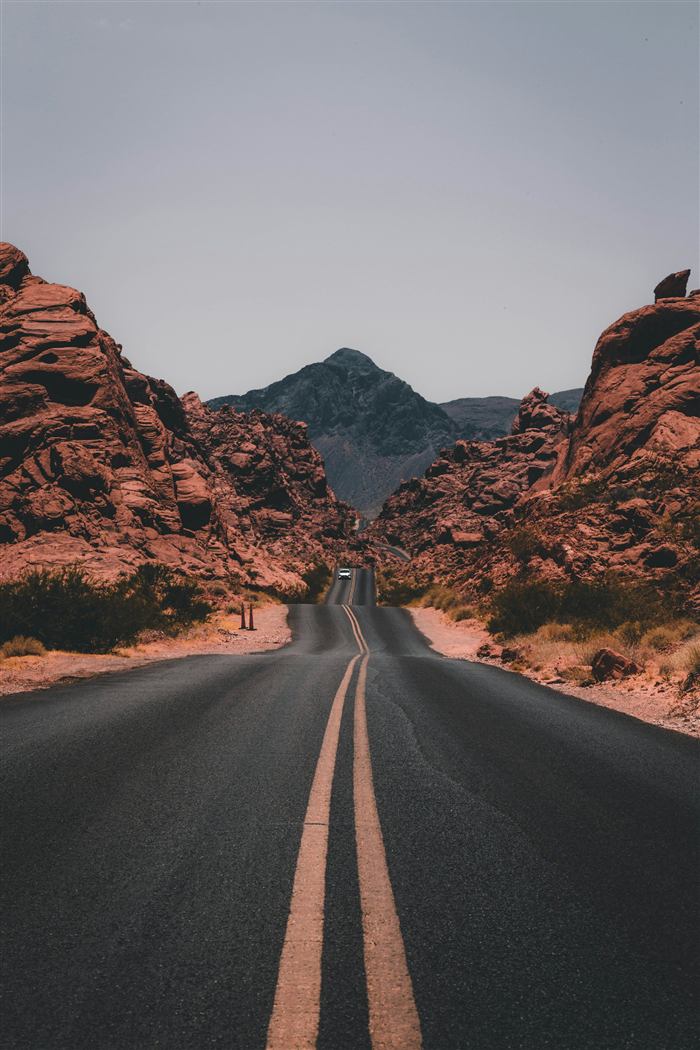An empty road winding through red rock country
