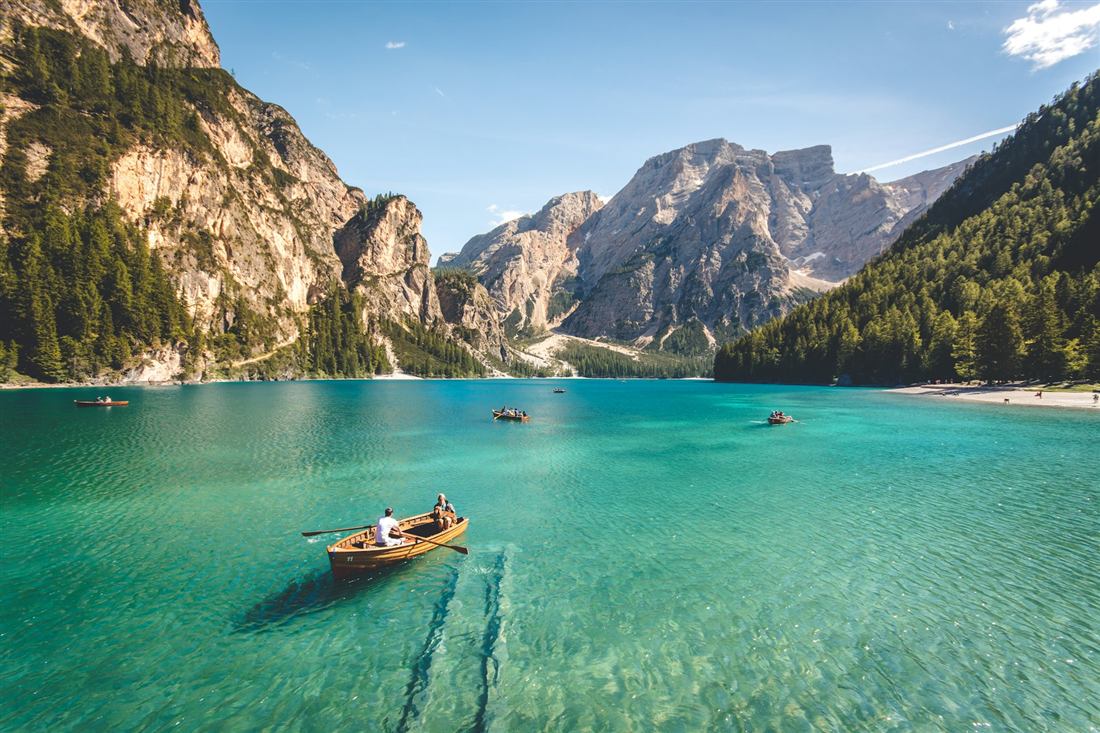 Wooden rowing boat on a turquoise mountain lake
